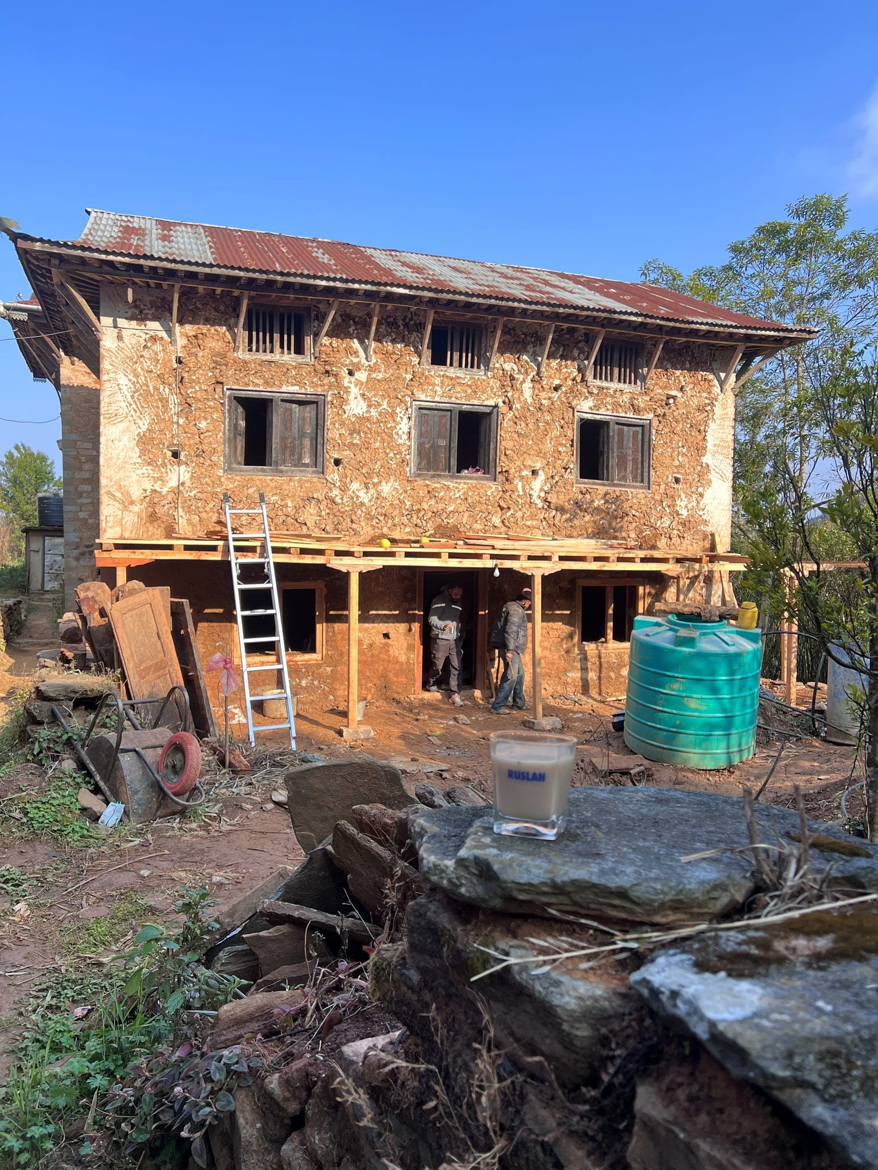 A stone house in Thumka with new timber posts along its front